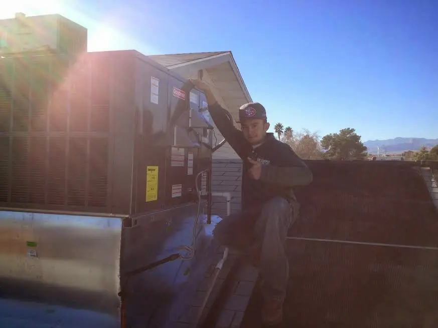 HVAC technician performing HVAC Inspection on a rooftop unit in Overlea